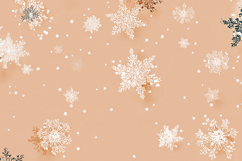 A peach-colored background with white and gold snowflakes Product Image 1