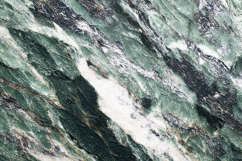 A green marble surface with white and black veins Product Image 1