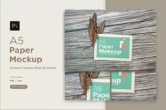 A5 paper mockup with dry leaves on wooden background Product Image 1