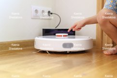 kids hand press button to turn the robot vacuum cleaner on Product Image 1