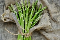 Fresh green asparagus wrapped in rustic burlap sackcloth Product Image 1