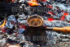 Metal cezve with hot flavored coffee on a bonfire closeup. Product Image 1