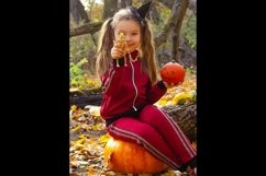 Girl in a witch&#039;s halloween hat and pumpkins in forest. Product Image 1