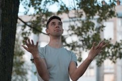 Young caucasian man walks in a park Product Image 1