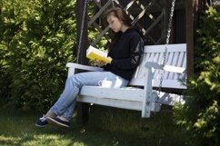 Pretty brunette in black hoodie sitting on swing Product Image 1