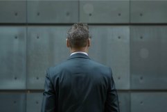 Businessman wearing suit standing with back turned in front Product Image 1