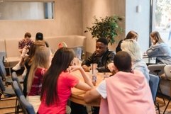 Group of friends in a cafe relaxing together Product Image 1