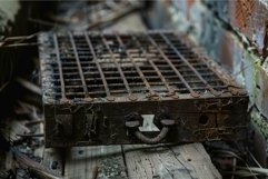 Rusty metal grate lying on wooden floor in abandoned buildin Product Image 1