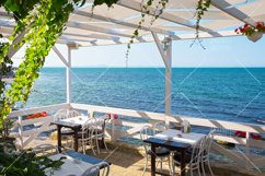 Cafe on sea coast with chairs and tables in Bulgaria Product Image 1