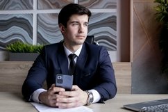 portrait of a businessman in a dark blue suit in the office Product Image 1