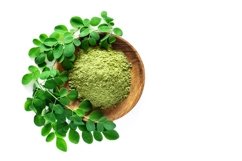 Moringa powder with fresh green leaves isolated on white Product Image 1