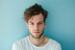 Confident young man against blue background Product Image 1