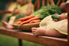 Little baby feet close up. Carrot basket Product Image 1