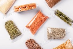 Vegan food supplies in plastic wrap on white background Product Image 1
