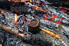 Metal cezve with hot coffee on a bonfire, top view. Product Image 1