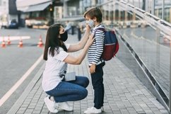 Schoolboy and mother wearing medical masks during a pandemic Product Image 1