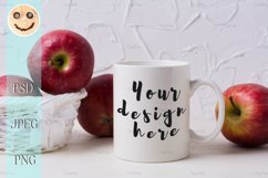 White coffee mug mockup with red apples in wicker basket Product Image 1