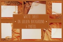 White sheet on golden fabric bakground