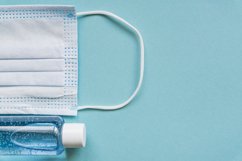medical mask and sanitizer on blue background. Product Image 1