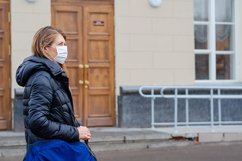 woman wears medical mask in the empty street. Product Image 1