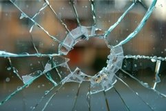 Detailed closeup of a broken glass pane with sharp fragments Product Image 1