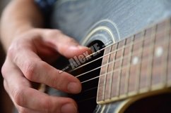 Playing the Wooden Acoustic Guitar Product Image 1