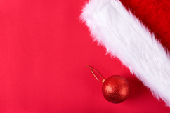 Santa hat and one bauble on red background Product Image 1