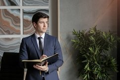 portrait of a businessman in a dark blue suit in the office Product Image 1