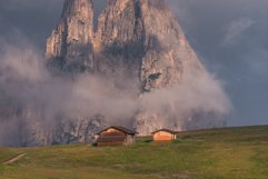 Cottages under Seiser Alm on a dramatic and gloomy day Product Image 1
