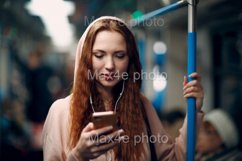 Young woman with mobile phone in subway. Product Image 1