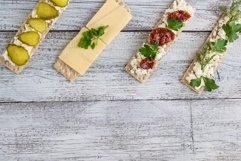 various crispbread slices on white wooden kitchen table Product Image 1