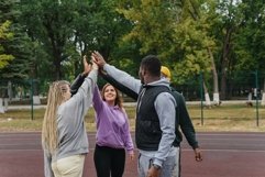 Diverse people put their hands in a stack doing sports Product Image 1