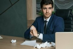 Angry businessman working with laptop in modern office. Crum Product Image 1