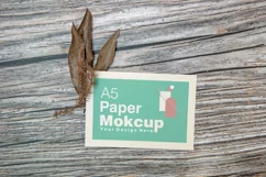 A5 paper mockup with dry leaves on wooden background Product Image 2