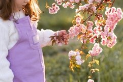 Cute baby girl with flowers outdoors Product Image 1