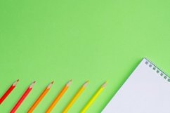 School and office supplies on office table, green background Product Image 1