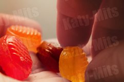 Hard sugar candies or cough drops in hand Product Image 1