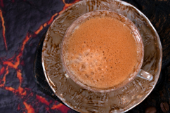 Black coffee with foam in a brown ceramic cup Product Image 1