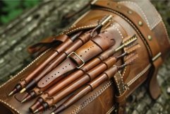 Leather quiver full of arrows lying on wooden surface Product Image 1