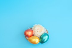 Decorated Easter eggs lie in the basket like a nest Product Image 1