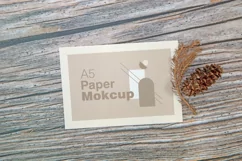 A5 paper mockup with dry leaves on wooden background Product Image 2