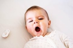 Little baby girl is yawning on her bed before go to sleep. Product Image 1