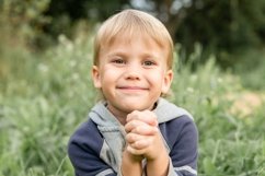 portrait face little smiling happy candid kid boy in nature Product Image 1