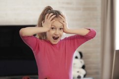 Emotional portrait of schoolgirl studying homework Product Image 1