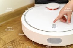 kids hand press button to turn the robot vacuum cleaner on Product Image 1