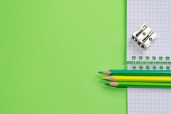 School and office supplies on office table, green background Product Image 1