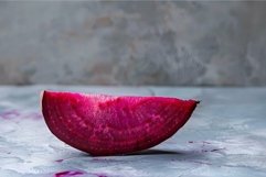 Single slice of fresh beetroot resting on a textured surface Product Image 1