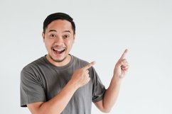 Happy Asian man pointing on empty space Product Image 1