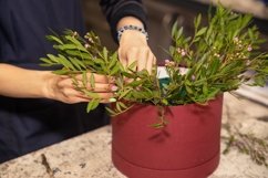 Florist makes a flower composition in the hat box Product Image 1