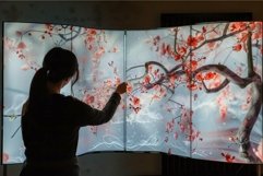 Curator touching interactive digital art installation of che Product Image 1